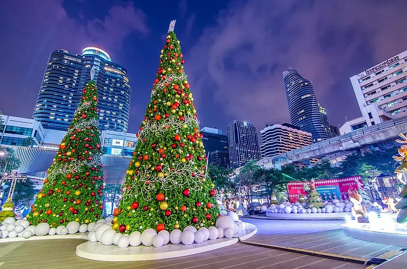 Bangkok Christmas decorations at night with large trees and city buildings