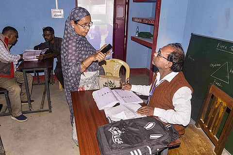 A booth level officer (BLO) interacts with a voter during verification of voter identification cards as part of 'Special Revision' (SR) of electoral rolls of Assam, in Guwahati.