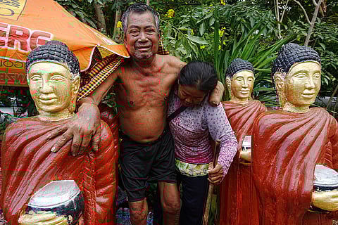 A sick man, left, is helped his balance by his wife, right, taking him to the hospital as they take refuge in Koak Kroal's Buddhist pagoda, Siem Reap province, Cambodia after fleeing from home following a fighting between Thailand and Cambodia over territorial claims. 
