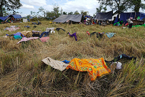 Evacuees dry clothes on paddy hay as they take refuge at Chonkal in Oddar Meanchey province, Cambodia after fleeing homes following fighting between Thailand and Cambodia over territorial claims. 