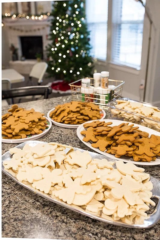 Table set up with plain white & ginger colored cookies for a Christmas cookie decorating station.