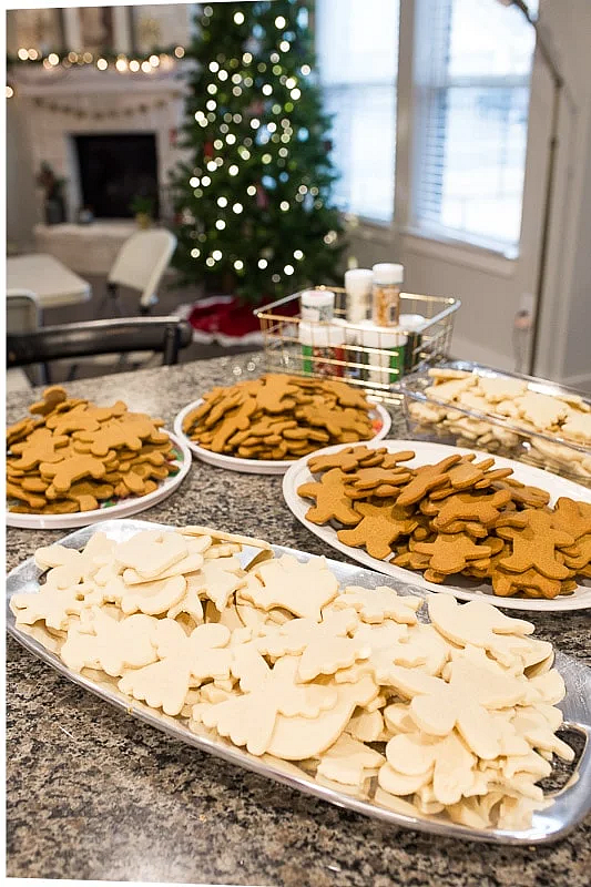 Table set up with plain white & ginger colored cookies for a Christmas cookie decorating station.