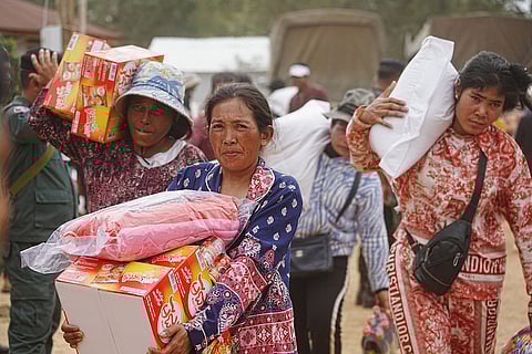 Evacuees receive donation as they take refuge in Oddar Meanchey province, Cambodia after fleeing from home following fighting between Thailand and Cambodia over territorial claims 