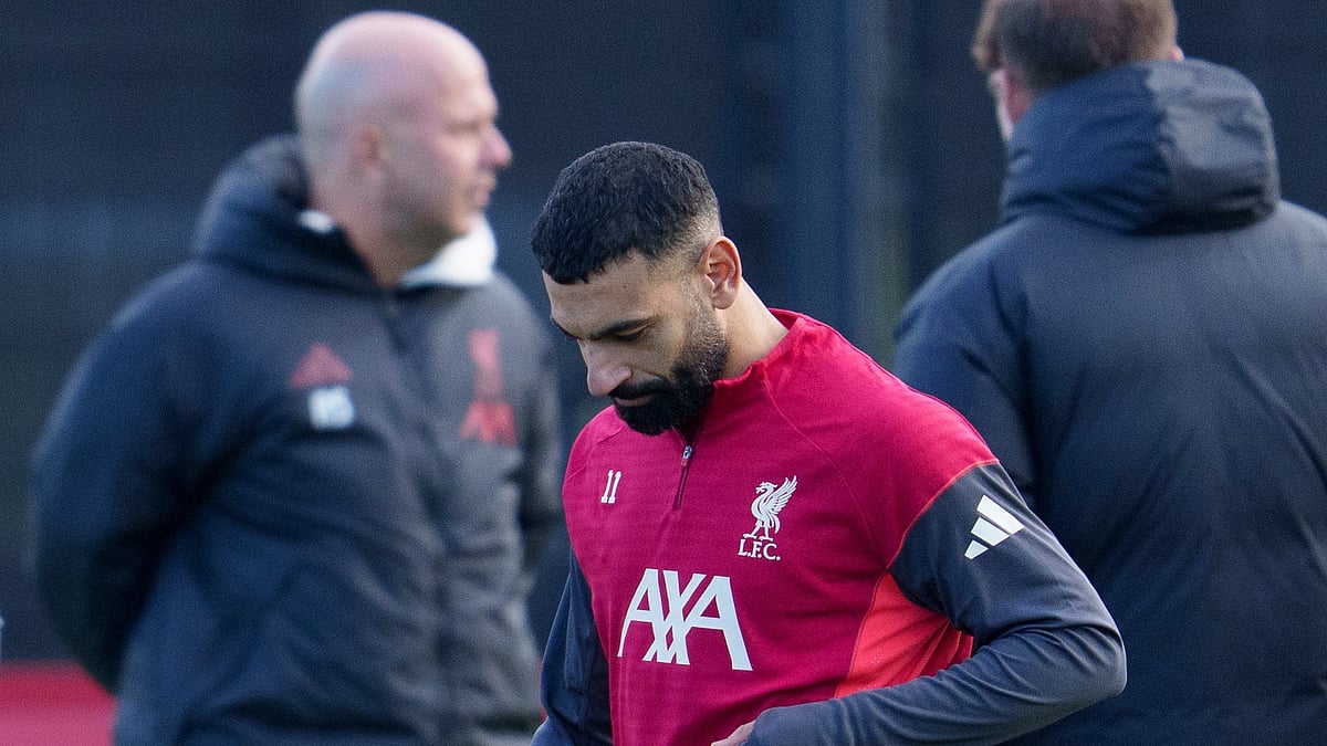 Liverpool's Mohamed Salah passes manager Arne Slot as he takes part in a training session on December 8, 2025. - | Photo: AP/Jon Super