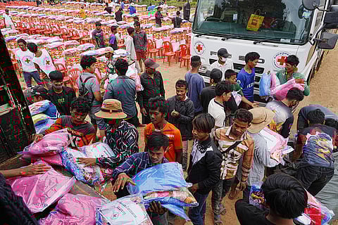 Yong evacuees help other evacuees to carry donation at Batthkoa Buddhist pagoda in Oddar Meanchey province, Cambodia after fleeing from home following fighting between Thailand and Cambodia over territorial claims 