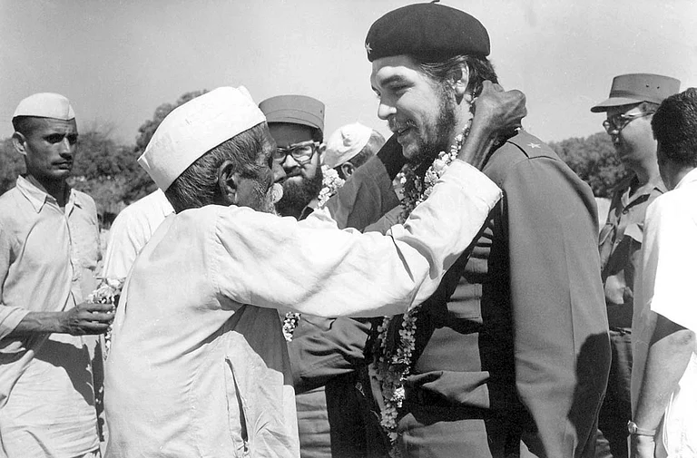 India Cuba: An elderly villager and member of indian communist party garlanding Che Guevara during his visit to a Community Project Area in Delhi, 1959
- null