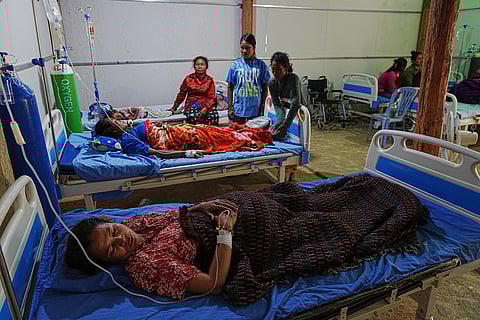 Evacuated people lie on beds at a medical health center as they take refuge in Batthkoa primary school in Oddar Meanchey province, Cambodia after fleeing  homes following fighting between Thailand and Cambodia over territorial claims. 