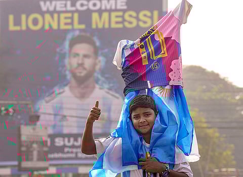 A fan poses for pictures during the unveiling of Argentine footballer Lionel Messi's 70-feet statue, in Kolkata. Messi virtually unveiled the statue as part of his 'G.O.A.T. India Tour 2025'.