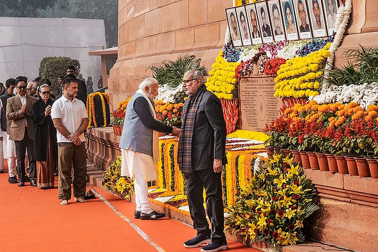 Prime Minister Narendra Modi pays tribute to the martyrs of the 2001 Parliament attack during a ceremony to mark its 24th anniversary, at Samvidhan Sadan, in New Delhi. Vice President CP Radhakrishnan and LoP in the Lok Sabha Rahul Gandhi are also seen. - | Photo: PTI/Shahbaz Khan
