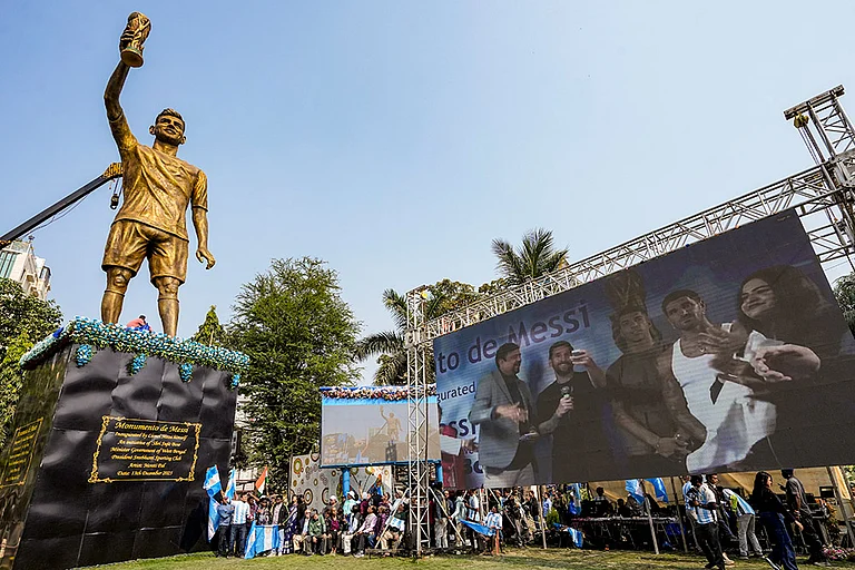 Argentine footballer Lionel Messi with TMC MLA Sujit Bose virtually unveils his 70-feet statue as part of his 'G.O.A.T. India Tour 2025', in Kolkata. - | Photo: PTI/Manvender Vashist Lav
