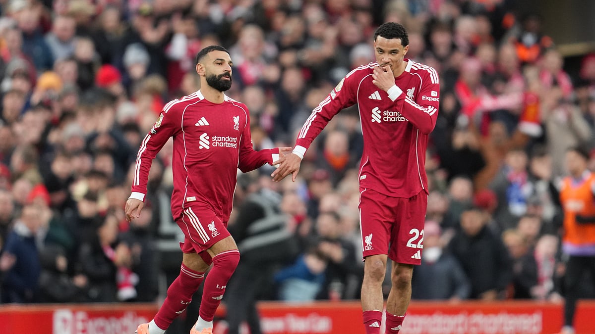 Liverpool's Mohamed Salah, left, and Liverpool's Hugo Ekitike during the English Premier League soccer match between Liverpool and Brighton and Hove Albion in Liverpool, England, Saturday, Dec. 13, 2025. - (AP Photo/Jon Super)