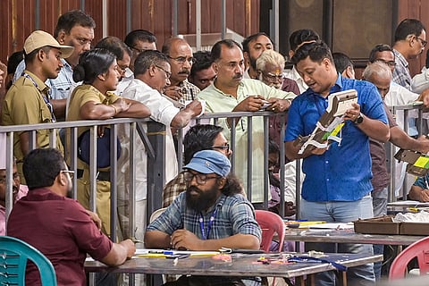 Political party workers witness the counting of votes for the Kerala local body elections, in Thiruvananthapuram.