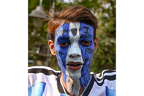 A fan of Argentine footballer Lionel Messi arrives at Vivekananda Yuba Bharati Krirangan (VYBK) to attend an event as part of his 'G.O.A.T. India Tour 2025', in Kolkata.