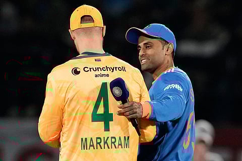 India's captain Suryakumar Yadav, right, talks with South Africa's captain Aiden Markram before the start of the third T20 cricket match between India and South Africa in Dharamshala.