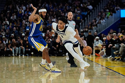 Minnesota Timberwolves guard Terrence Shannon Jr. (1) moves the ball while defended by Golden State Warriors guard Moses Moody (4) during the second half of an NBA basketball game in San Francisco. 