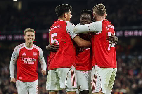 Arsenal's Bukayo Saka, second right, celebrates with teammates after his team scored the opening goal during the English Premier League soccer match between Arsenal and Wolves in London.