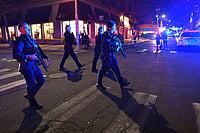 Two killed, Eight Injured In Shooting At Brown University Campus Steven Senne : Law enforcement officials carry rifles while walking on a street in a neighborhood near Brown University in Providence, R.I., on Saturday, Dec. 13, 2025 during the investigation of a shooting.