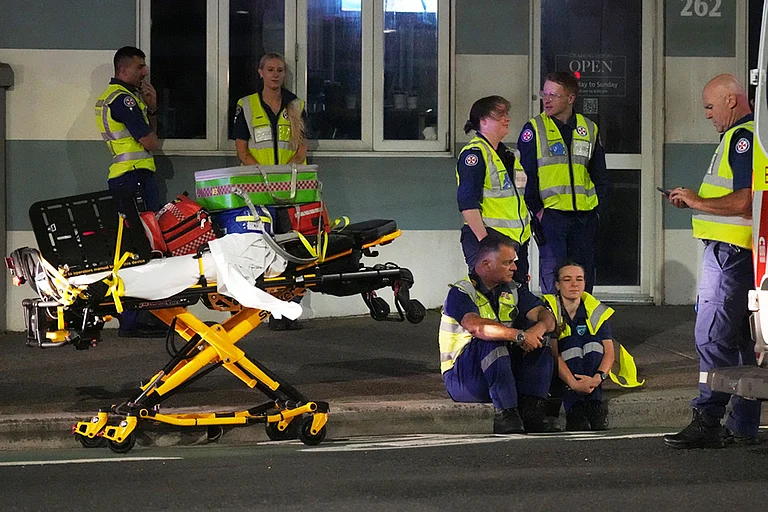Emergency workers standby at Bondi Beach after a reported shooting in Sydney. - | Photo: AP/Mark Baker
