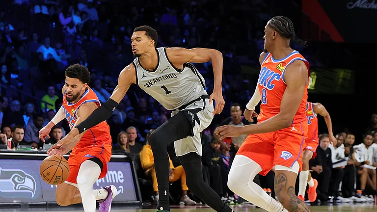 Ajay Mitchell #25 of the Oklahoma City Thunder steals the ball from Victor Wembanyama #1 of the San Antonio Spurs as Jalen Williams #8 of the Thunder defends in the second quarter of a semifinal game of the Emirates NBA Cup at T-Mobile Arena on December 13, 2025 in Las Vegas, Nevada. - null