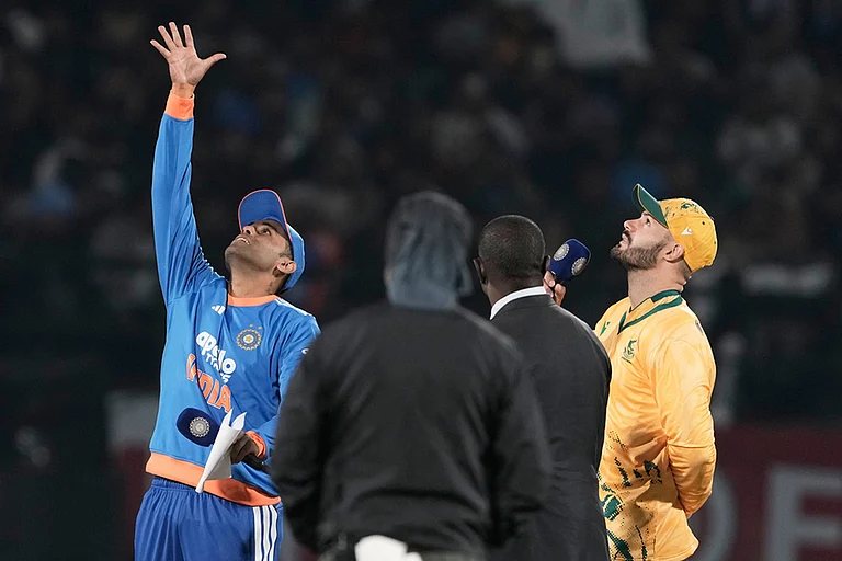 India's captain Suryakumar Yadav, left, toss the coin as South Africa's captain Aiden Markram, right, watch it during the third T20 cricket match between India and South Africa in Dharamshala. - | Photo: AP/Ashwini Bhatia