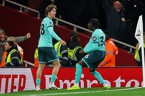 Wolverhampton Wanderers' Fer Lopez, left, and Mateus Mane celebrate after their team scored their first goal during the English Premier League soccer match between Arsenal and Wolves in London.