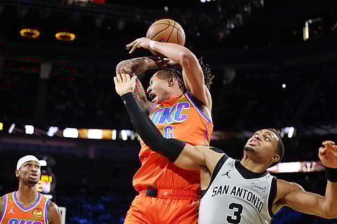 Oklahoma City Thunder forward Jaylin Williams (6) and San Antonio Spurs forward Keldon Johnson (3) collide while going for a rebound during the second half of an NBA Cup semifinals basketball game in Las Vegas. 