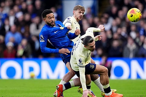 Chelsea's Reece James, left, battles for the ball with Everton's Jack Grealish, right, and Kiernan Dewsbury-Hall during the English Premier League soccer match between Chelsea and Everton in London.
