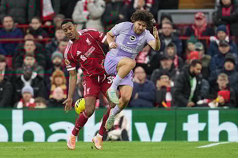 Liverpool's Ryan Gravenberch, left, challenges for the ball with Brighton's Ferdi Kadioglu during the English Premier League soccer match between Liverpool and Brighton and Hove Albion in Liverpool, England.