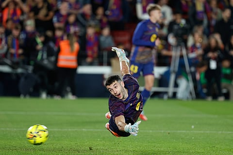 Barcelona's goalkeeper Joan Garcia warms up for a La Liga soccer match between Barcelona and Osasuna in Barcelona, Spain.