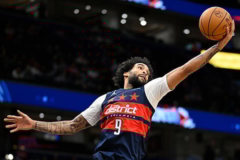 Washington Wizards forward Justin Champagnie grabs a rebound during the first half of an NBA basketball game against the Cleveland Cavaliers in Washington. 