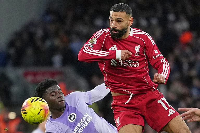 Liverpool's Mohamed Salah, right, challenges for the ball with Brighton's Carlos Baleba, left, during the English Premier League soccer match between Liverpool and Brighton and Hove Albion in Liverpool, England. - | Photo: AP/Jon Super