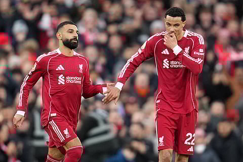 Liverpool's Mohamed Salah, left, and Liverpool's Hugo Ekitike greet each other during the English Premier League soccer match between Liverpool and Brighton and Hove Albion in Liverpool, England.