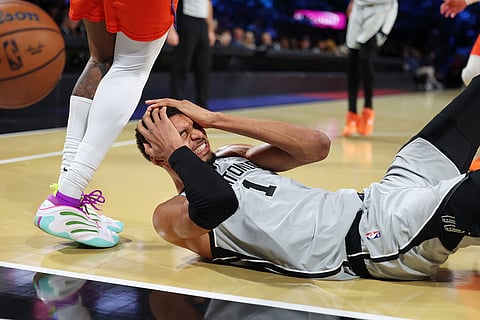 San Antonio Spurs forward Victor Wembanyama (1) lands on the court during the second half of an NBA Cup semifinals basketball game against the Oklahoma City Thunder in Las Vegas. 
