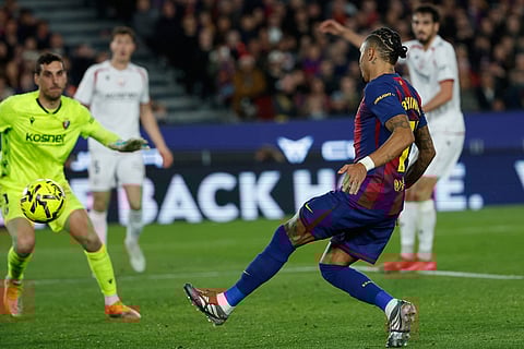 Barcelona's Raphinha scores during a La Liga soccer match between Barcelona and Osasuna in Barcelona, Spain.