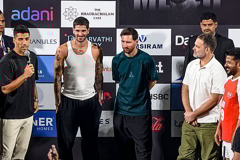 Leader of Opposition in the Lok Sabha Rahul Gandhi, second right, and Telangana Chief Minister Revanth Reddy, right, with Argentine footballer and 2022 FIFA World Cup winning captain Lionel Messi, center, and his Inter Miami teammates Rodrigo De Paul, second left, and Luis Suarez during the second leg of 'GOAT India Tour 2025', in Hyderabad.