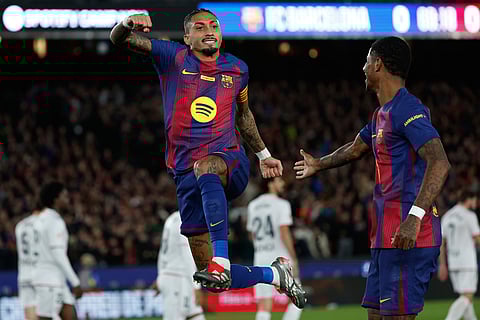 Barcelona's Raphinha celebrates after scoring during a La Liga soccer match between Barcelona and Osasuna in Barcelona, Spain.