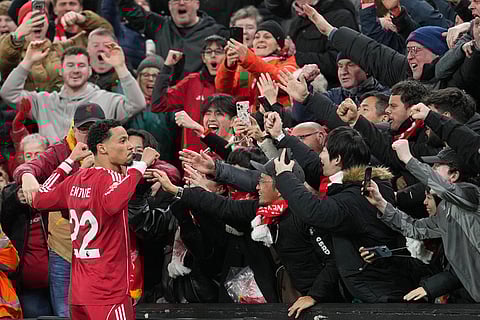 Liverpool's Hugo Ekitike celebrates with fans after scoring his side's second goal during the English Premier League soccer match between Liverpool and Brighton and Hove Albion in Liverpool, England.