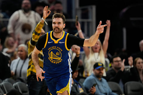 Golden State Warriors guard Pat Spencer (61) celebrates after making a 3-point basket during the second half of an NBA basketball game against the Minnesota Timberwolves in San Francisco. 