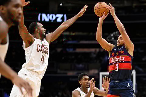 Washington Wizards guard CJ McCollum (3) prepares to shoot a 3-point basket against Cleveland Cavaliers center Evan Mobley (4) during the second half of an NBA basketball game in Washington. 