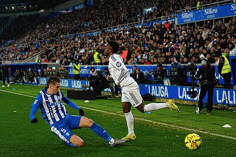 Real Madrid's Vinicius Junior, right, and Alaves' Jon Pacheco challenge for the ball during the Spanish La Liga soccer match between Alaves and Real Madrid in Vitoria-Gasteiz, Spain.