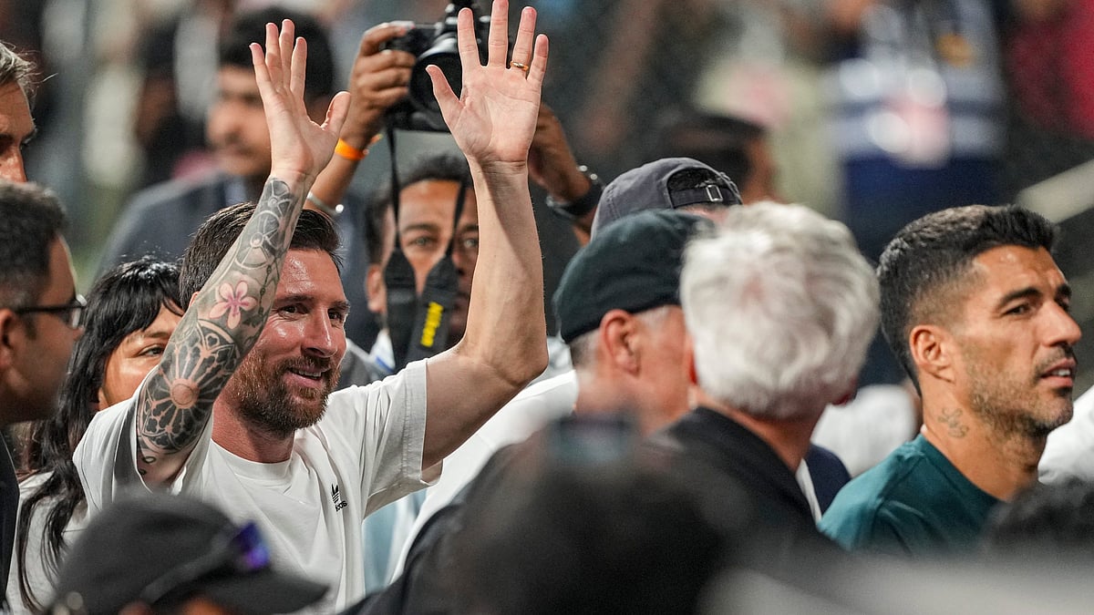 Argentine footballer and 2022 FIFA World Cup winning captain Lionel Messi, left, greets fans during an event as part of the 'GOAT India Tour 2025', at the Wankhede Stadium, in Mumbai, Sunday, Dec. 14, 2025. Inter Miami player Luis Suarez, right, is also seen.  - | Photo: PTI/Kunal Patil