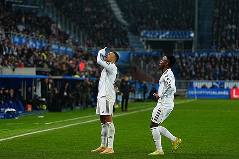 Real Madrid's Kylian Mbappe, left, celebrates with Real Madrid's Vinicius Junior after scoring the opening goal during the Spanish La Liga soccer match between Alaves and Real Madrid in Vitoria-Gasteiz, Spain.