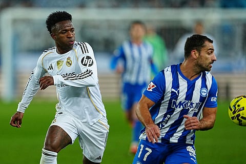 Real Madrid's Vinicius Junior, left, and Alaves' Jonny Otto challenge for the ball during the Spanish La Liga soccer match between Alaves and Real Madrid in Vitoria-Gasteiz, Spain.