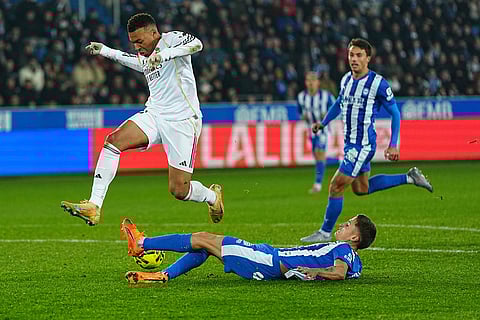 Real Madrid's Kylian Mbappe, left, and Alaves' Nahuel Tenaglia challenge for the ball during the Spanish La Liga soccer match between Alaves and Real Madrid in Vitoria-Gasteiz, Spain.