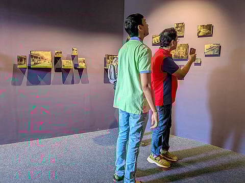 Visitors view photographs by visual artist Mrinal Bahukhandi at the 10th Serendipity Arts Festival, in Panaji, Goa. 