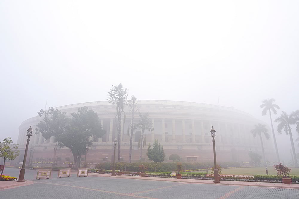 A view of the Parliament House complex on a foggy winter morning, in New Delhi.  - | Photo: PTI/Shahbaz Khan