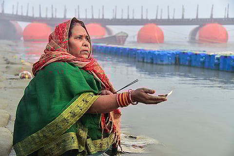 A woman offers prayers on the occasion of Saphala Ekadashi at the Sangam, in Prayagraj.