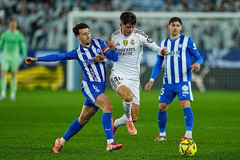 Real Madrid's Víctor Valdepenas, centre, and Alaves' Antonio Blanco, left, challenge for the ball during the Spanish La Liga soccer match between Alaves and Real Madrid in Vitoria-Gasteiz, Spain.