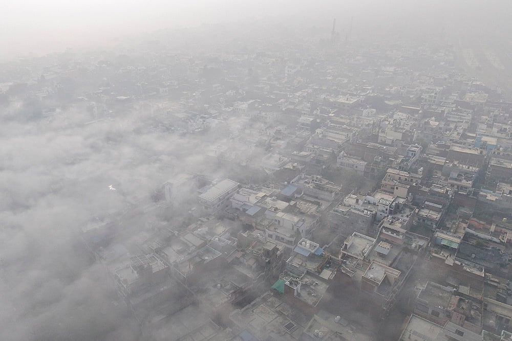 An aerial view shows the city enveloped in dense fog on a cold winter morning, in Prayagraj. - | Photo: PTI