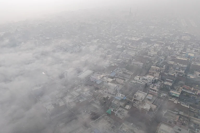 An aerial view shows the city enveloped in dense fog on a cold winter morning, in Prayagraj. - | Photo: PTI